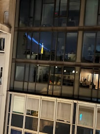 Reflection of lit-up Eiffel Tower taken from balcony