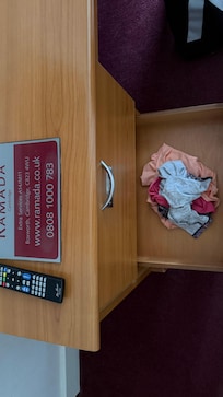 Someone else dirty clothes and underwear left in the room