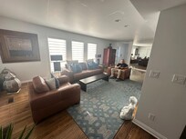 Middle floor sitting room with central double sided fireplace, gorgeous kitchen with large island. TV and large dining room table. (Not in photo)