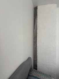 Wall in bedroom behind the fireplace