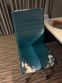 This was the desk chair in my room. The air conditioner did not work. The phone did not work on arrival. The toilet seat was only attached on one side and none of the ice machines on any floor worked. The carpet is so filthy and stained.