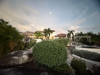 From the top of a rock looking back at the home with the moon.