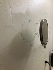 Behind mirror near sink area