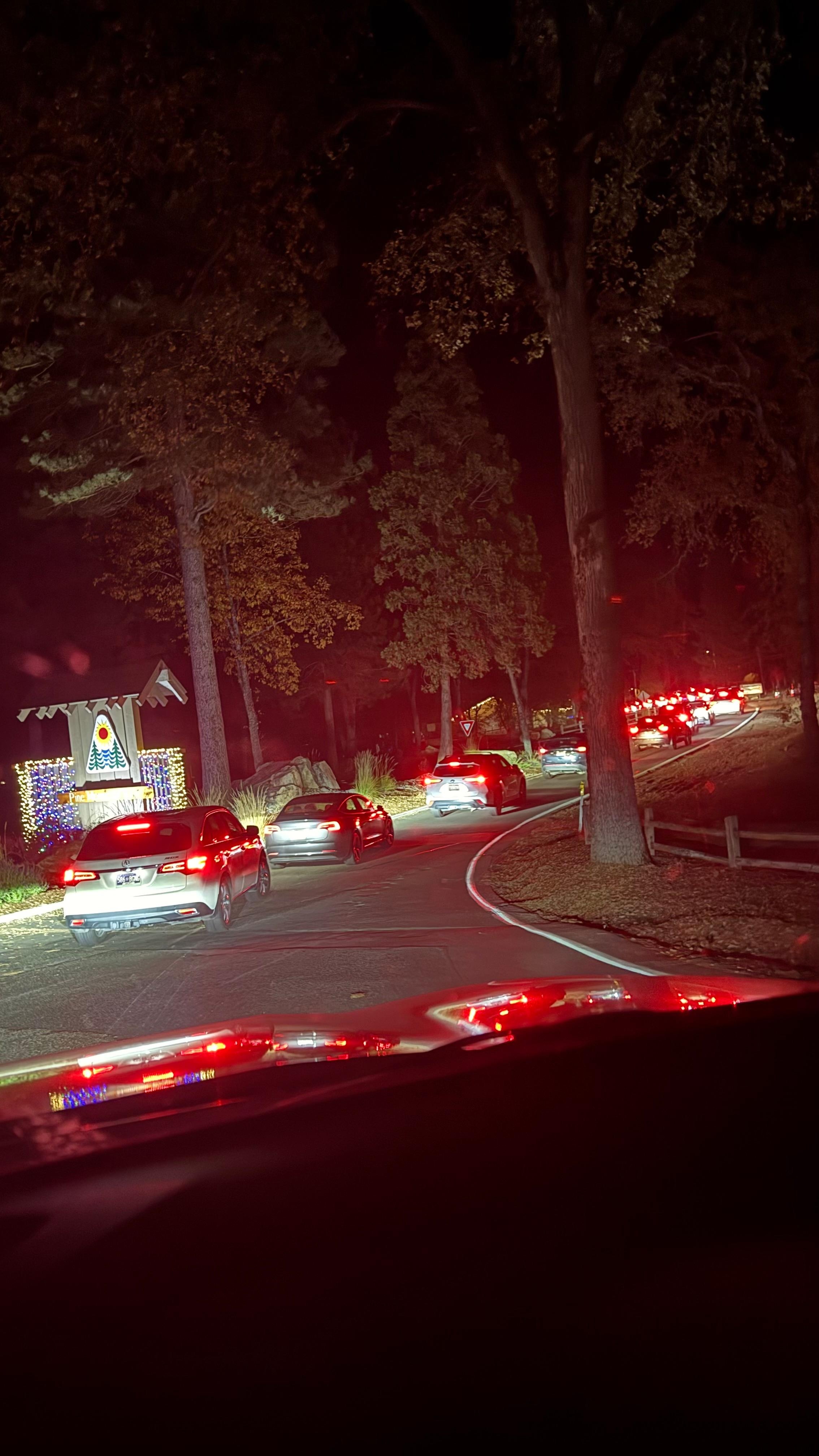 Line of cars waiting to get in through the gate of the compound.