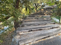 Stairs to front door with steep side drop