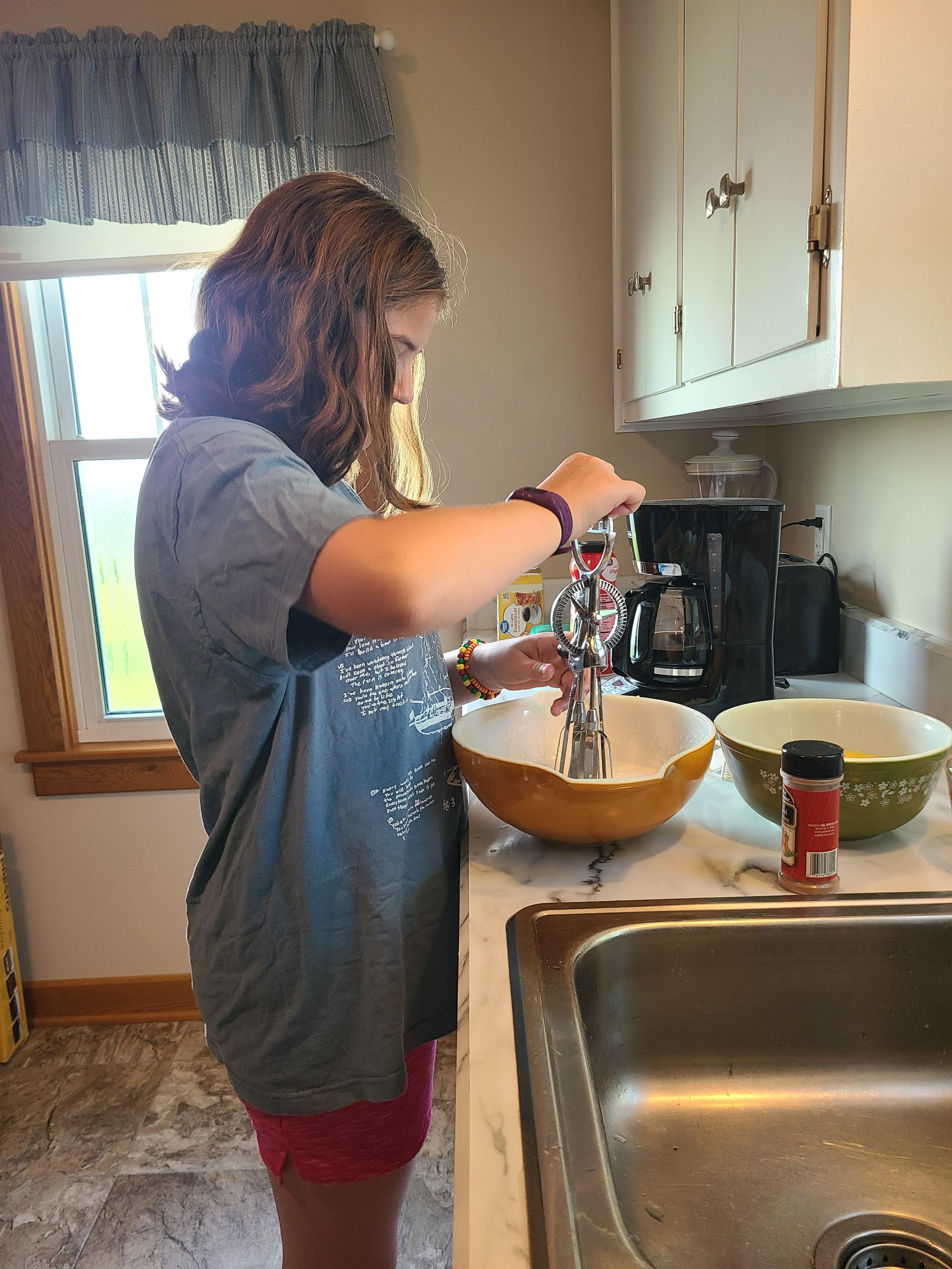 Max making breakfast with the hand mixer