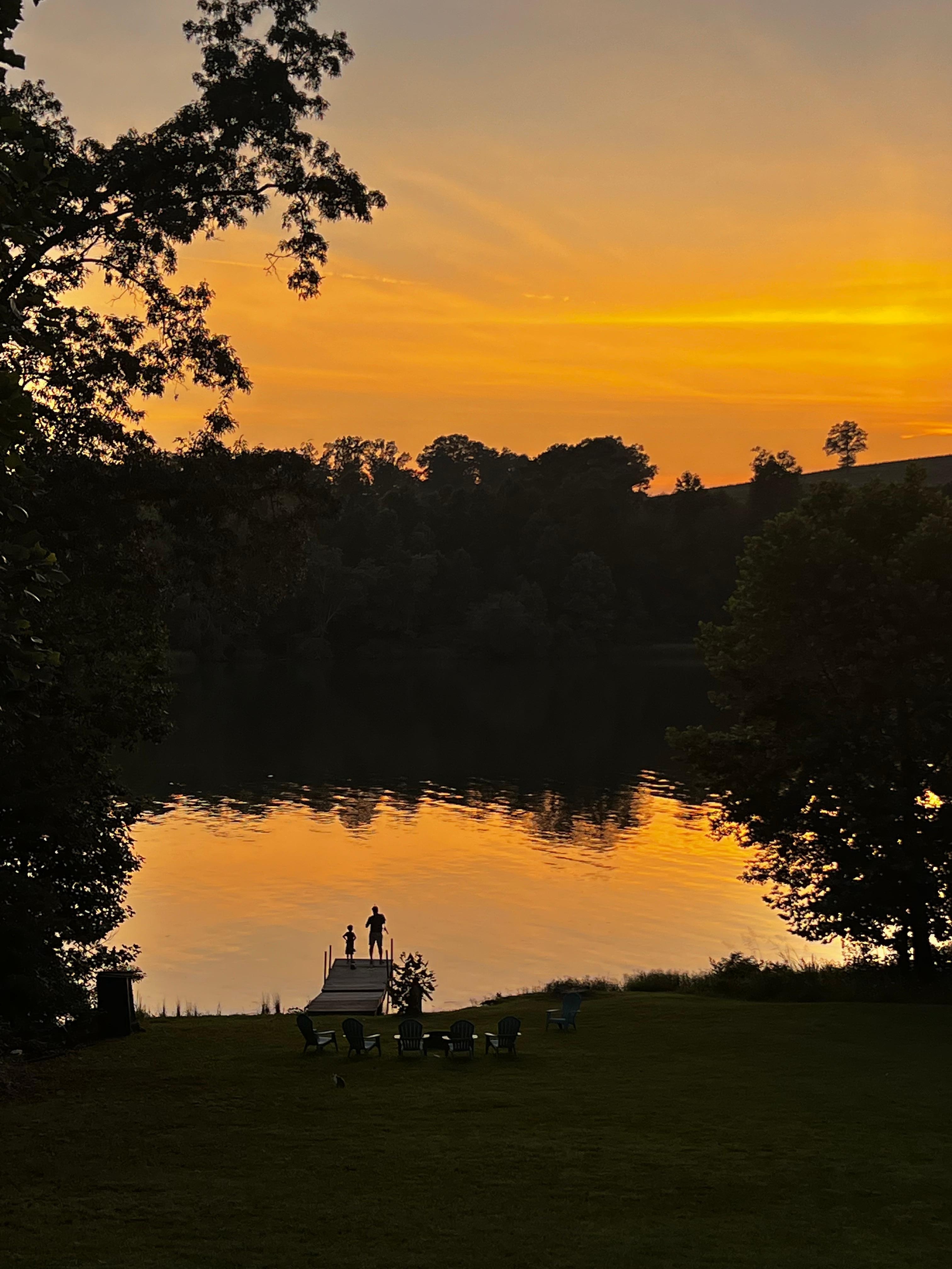Daddy and son on the dock at sunset 
