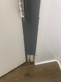 Trim around door sawn off, with terrible paint job (see hinge).