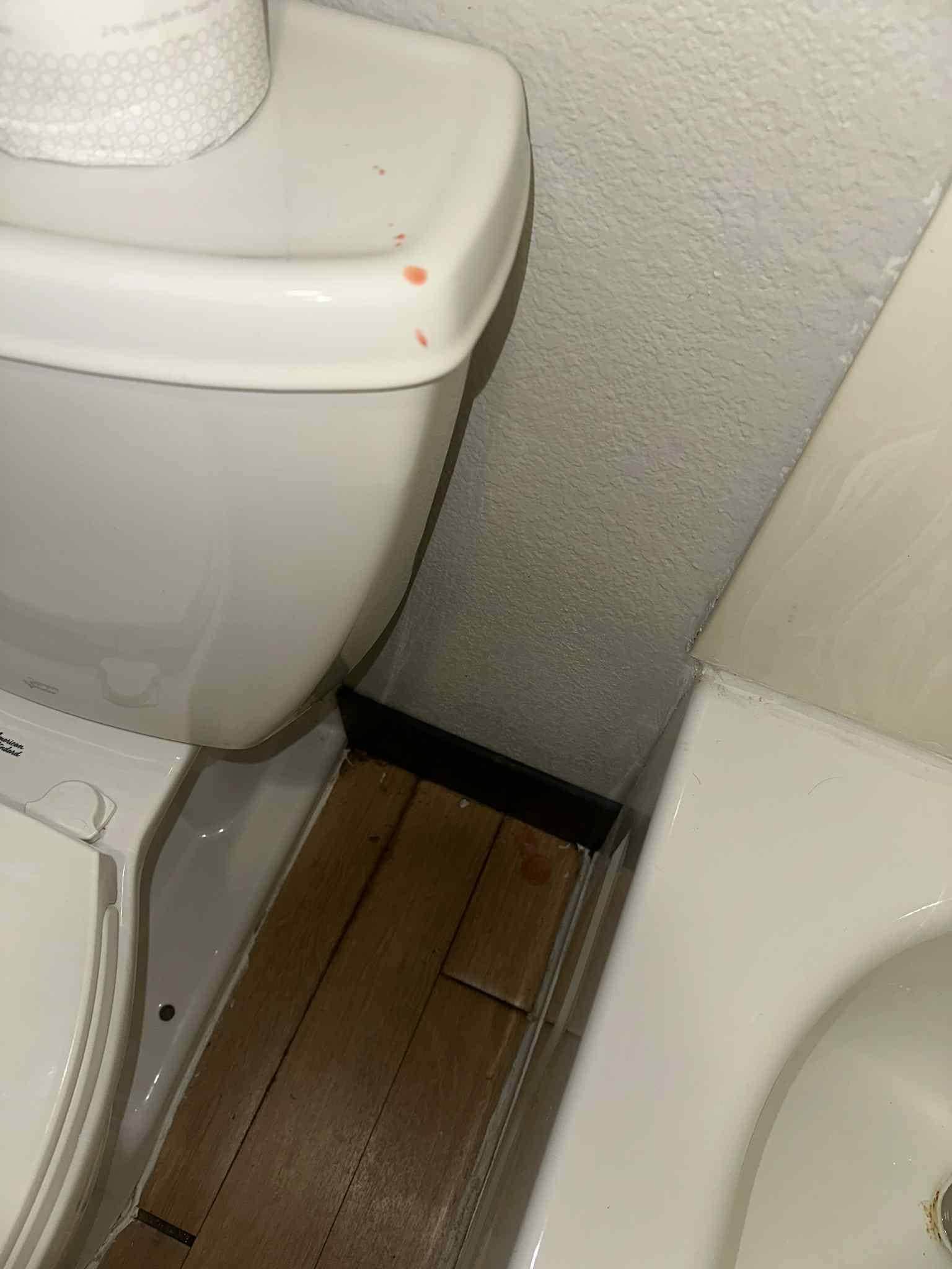 Melted candle wax on the toilet and floor