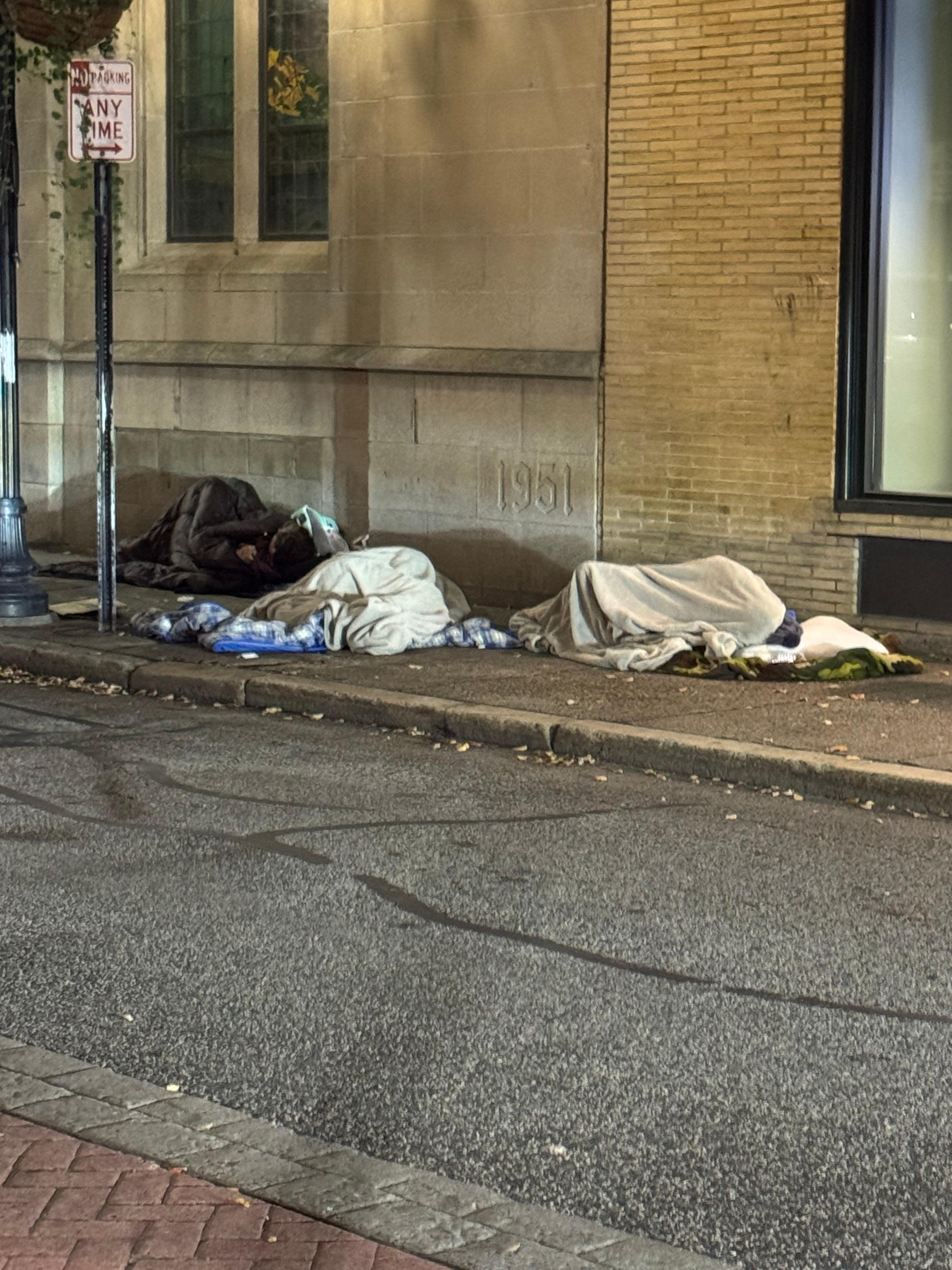 People sleeping in front of the hotel