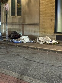 People sleeping in front of the hotel