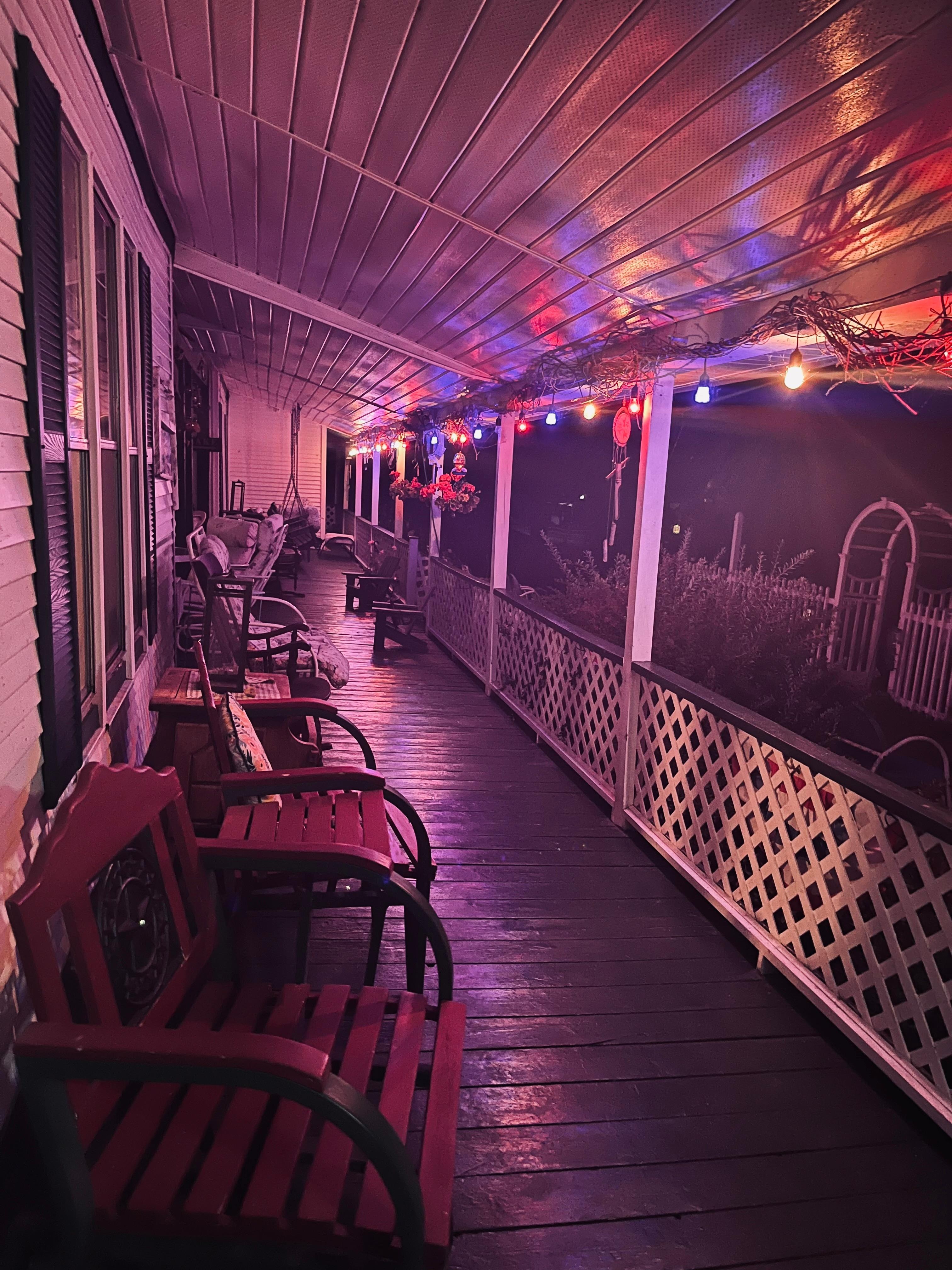 The front Patio at night! Plenty of rocking chairs. 