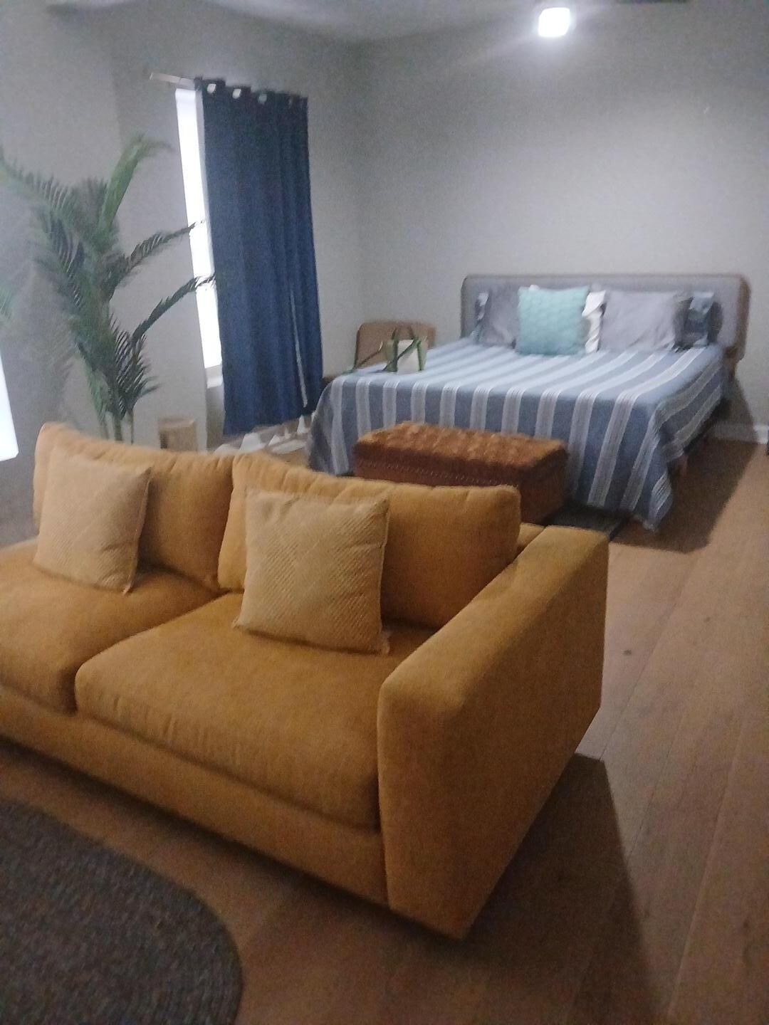 Master bedroom with a sitting area and large tv a walkin closet and bathroom!