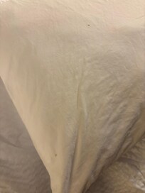Stained pillow cases with red/brown color