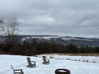 Fire pit area right off their huge porch with a hammock!
