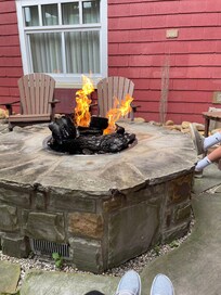 Fire pit with chairs outside lodge