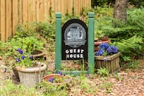 Guest House sign and flowers