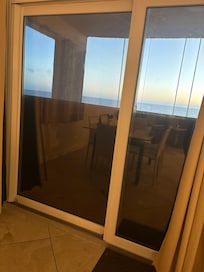 Balcony boarded. Board blows in the wind against the window