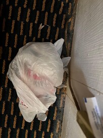 Trash behind nightstand