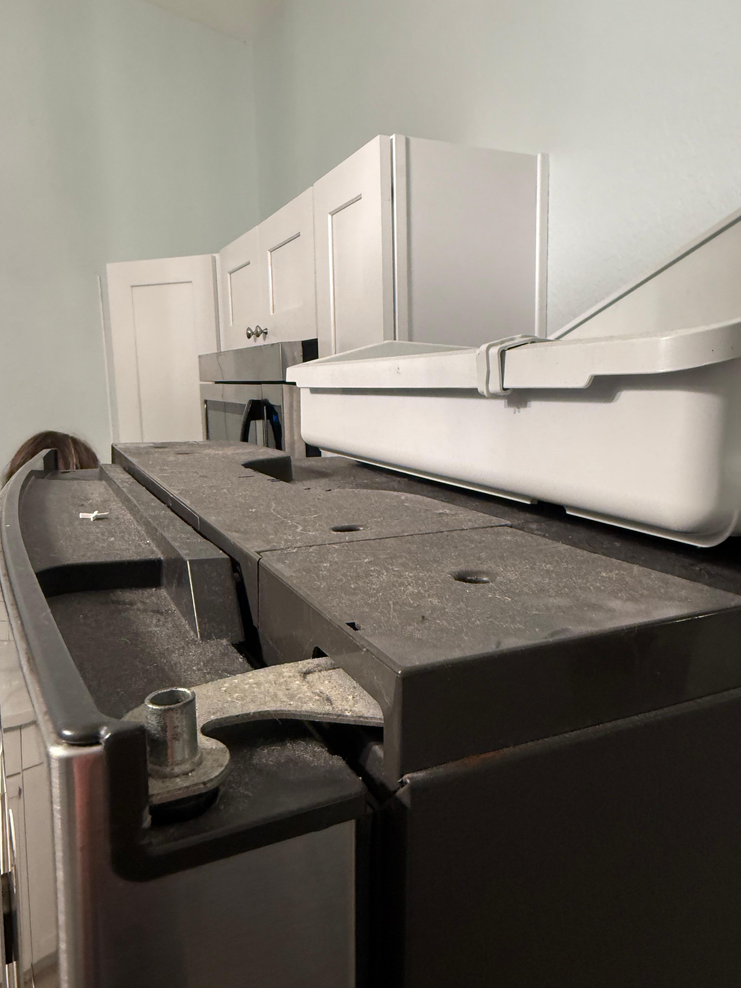 Filth on top of the fridge.