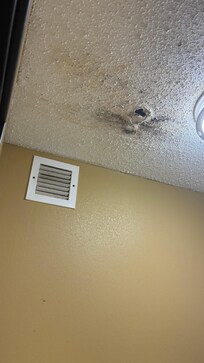 Room 124 the bathroom ceiling has a hole from water damage