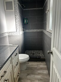 En-suite bathroom off master. No shower curtain.