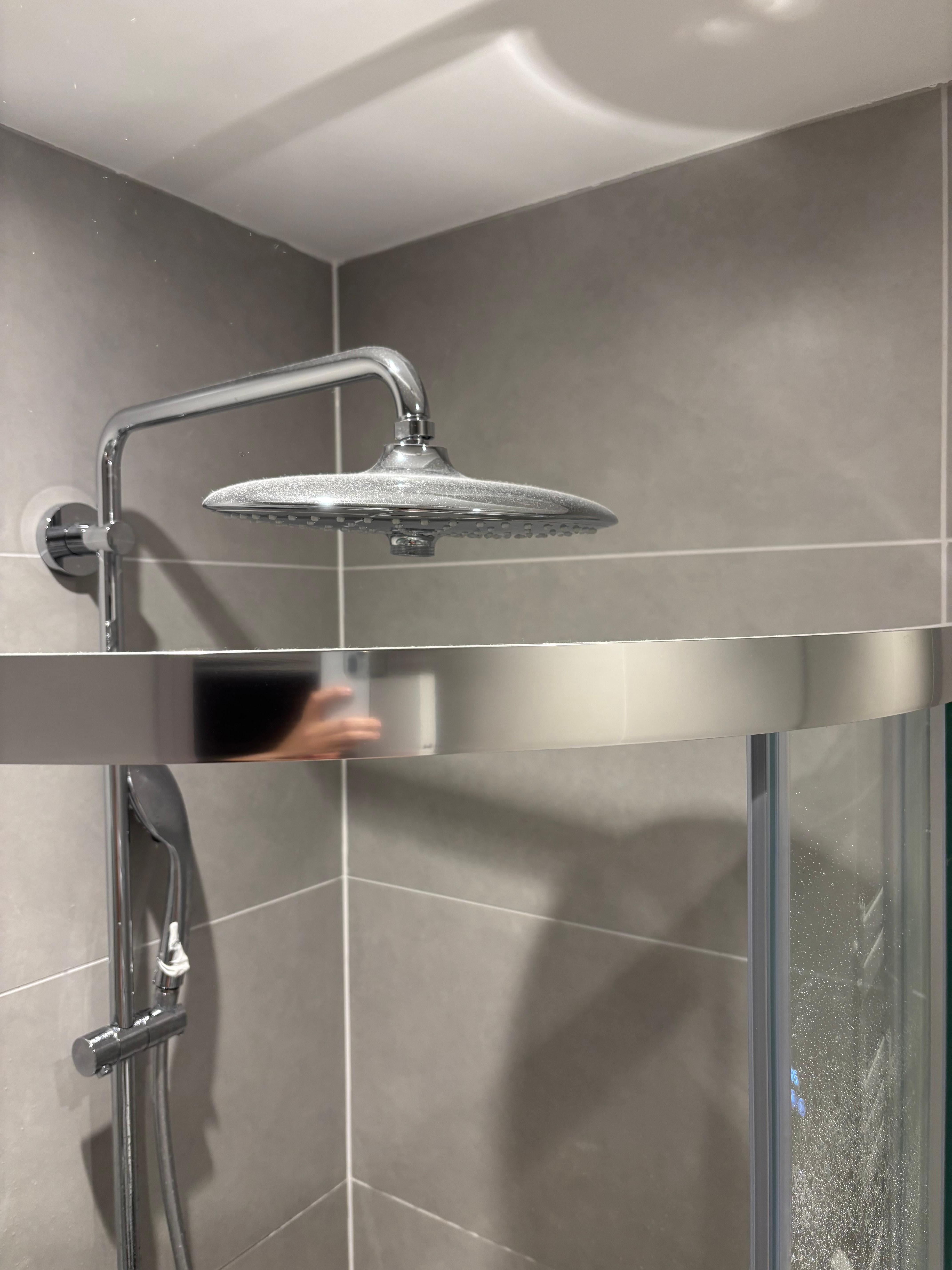 Proximity of shower head to cubicle. And dust