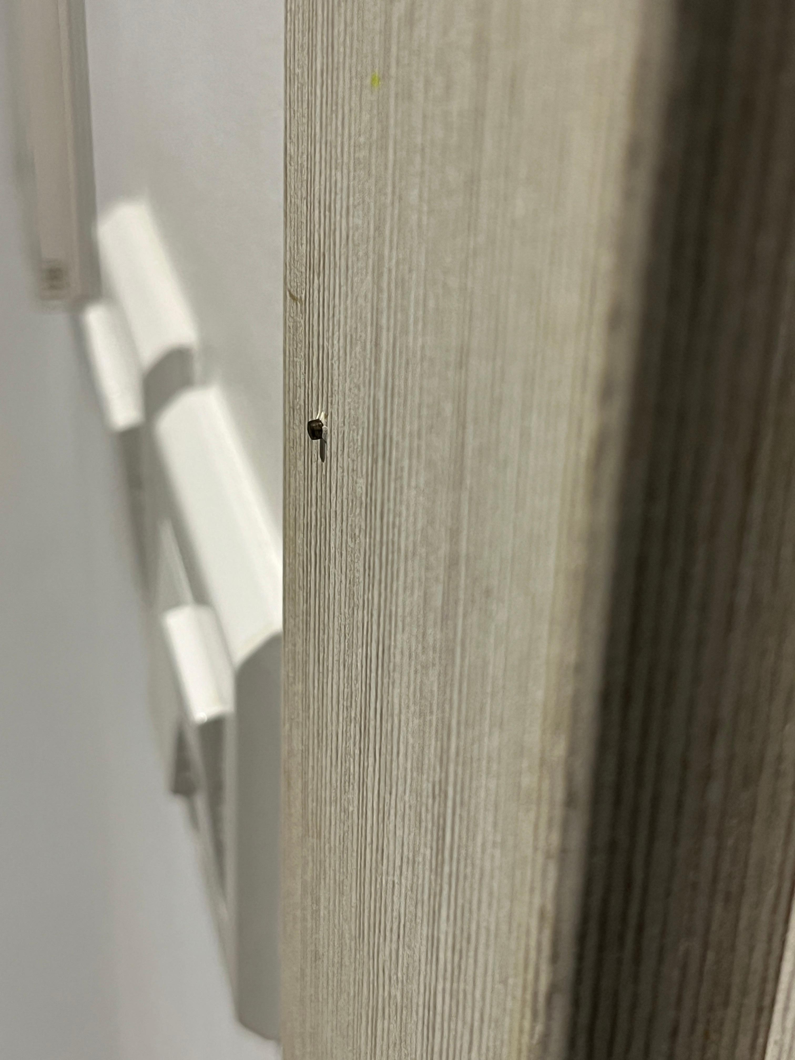 Nails protruding from architrave