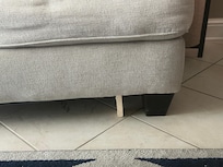 Couch held up by wood block