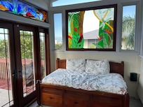 Daybed and stained glass in an alcove off of the living room.