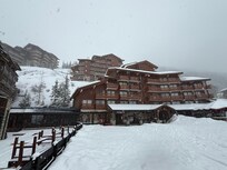 Building up & behind to the left is the actual property. Access to slopes is from the ground layer entrance in this photo.