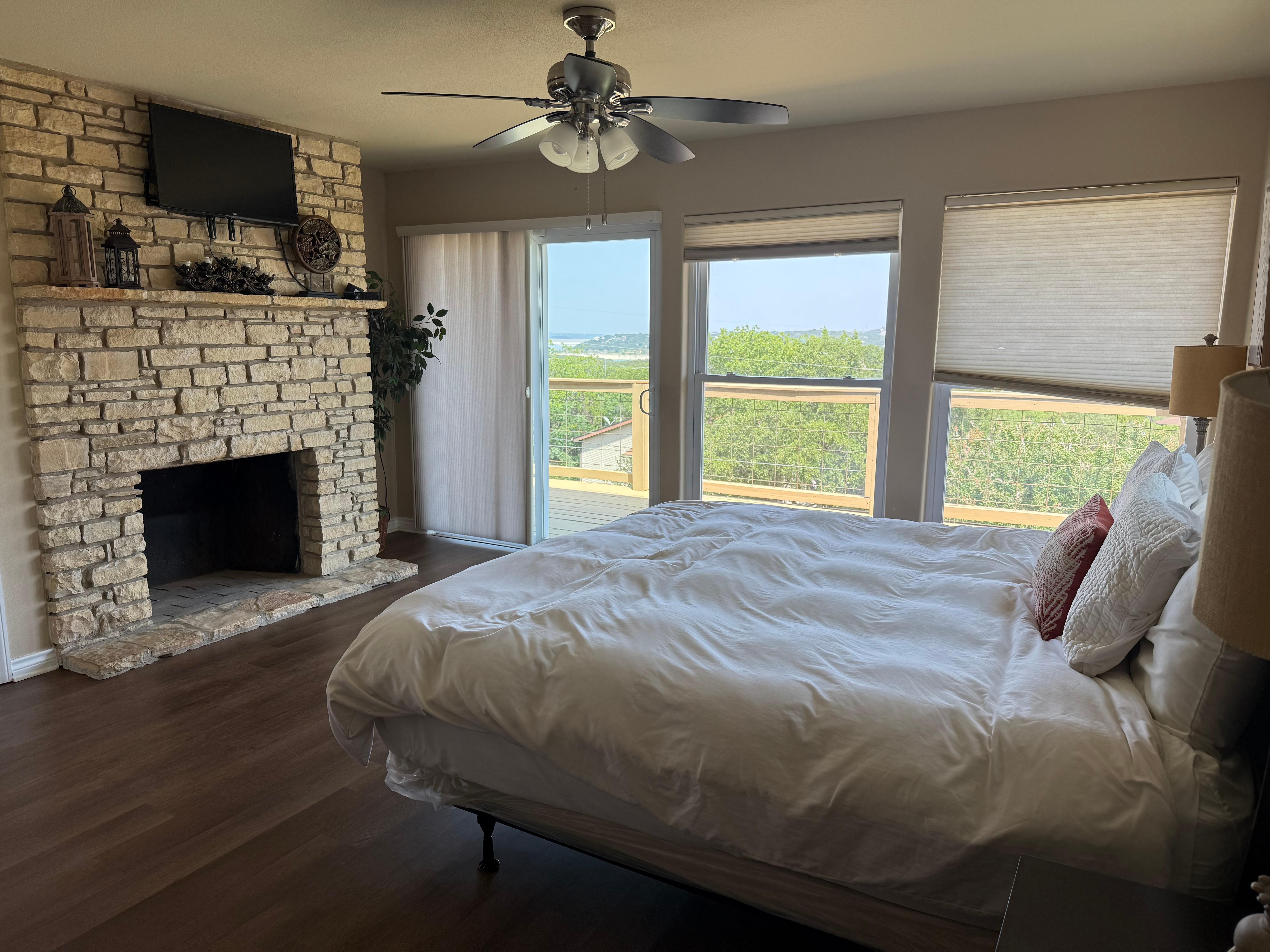 Master bed and fireplace with view