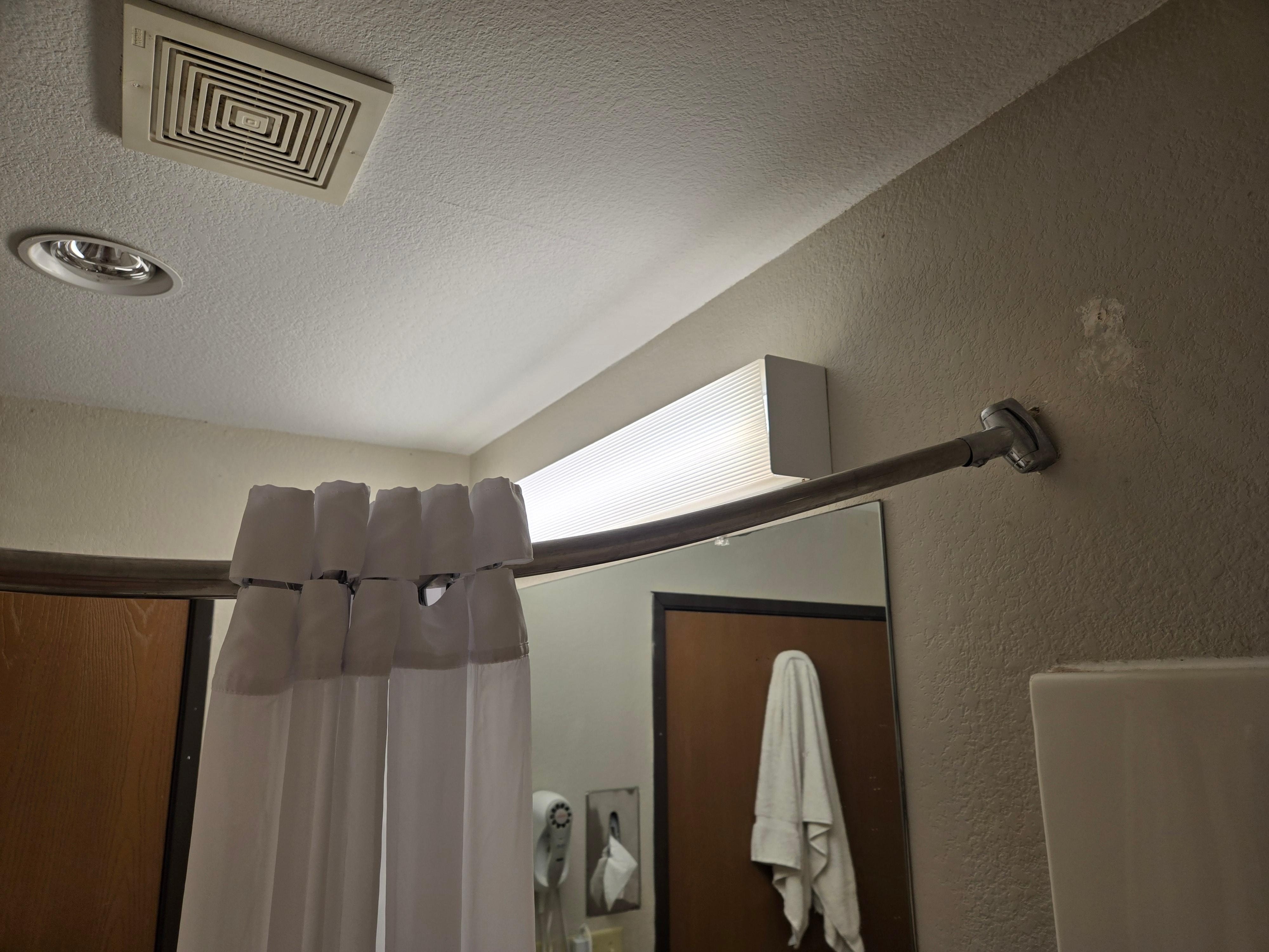 Shower curtain rod pulling out of the wall, so curtain would only cover the small area pictured.