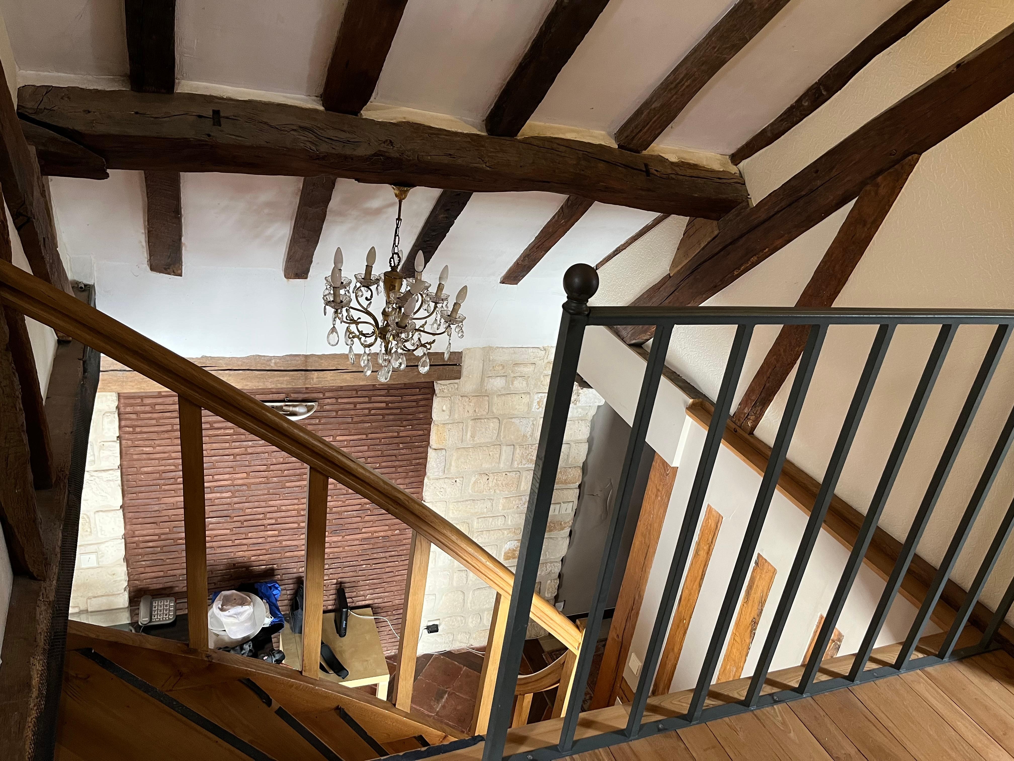 Stairs from second-story bedroom/bathroom down to living/kitchen and downstairs bathroom