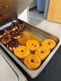 The donuts were sitting in puddles of water.