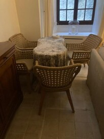 Living area dominated by locked wardrobe and very large sofa and hearth leaves very little space for eating area