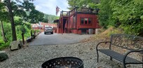 Fire pit behind caboose and master suite, rooftop deck above master