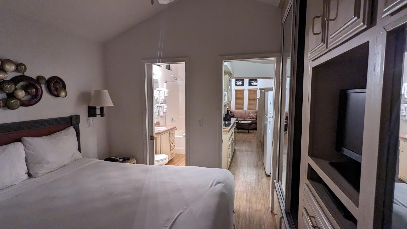 Bedroom looking into bathroom and kitchen, living room