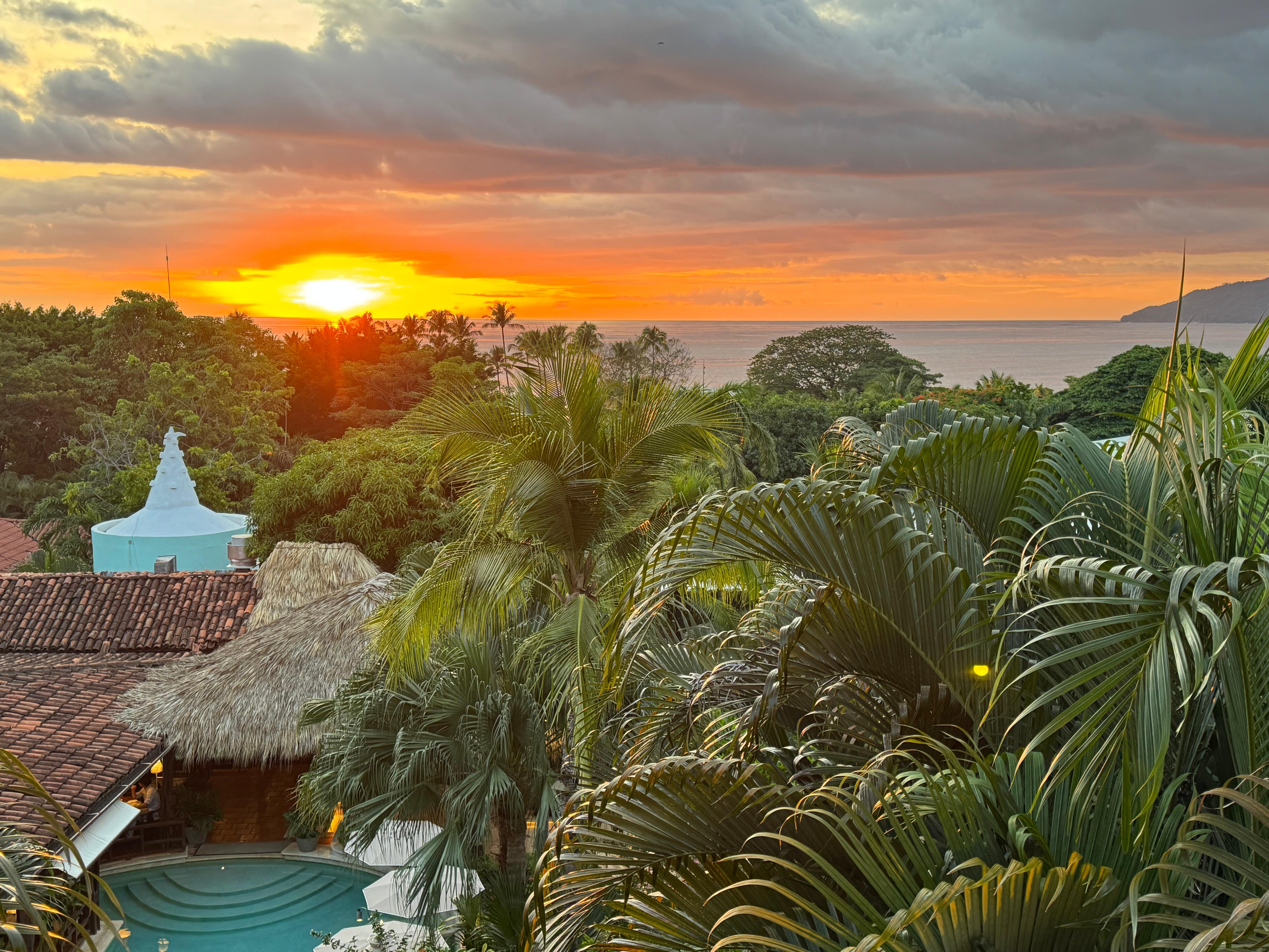 Sunset ocean view overlooking the pool from hotel room 