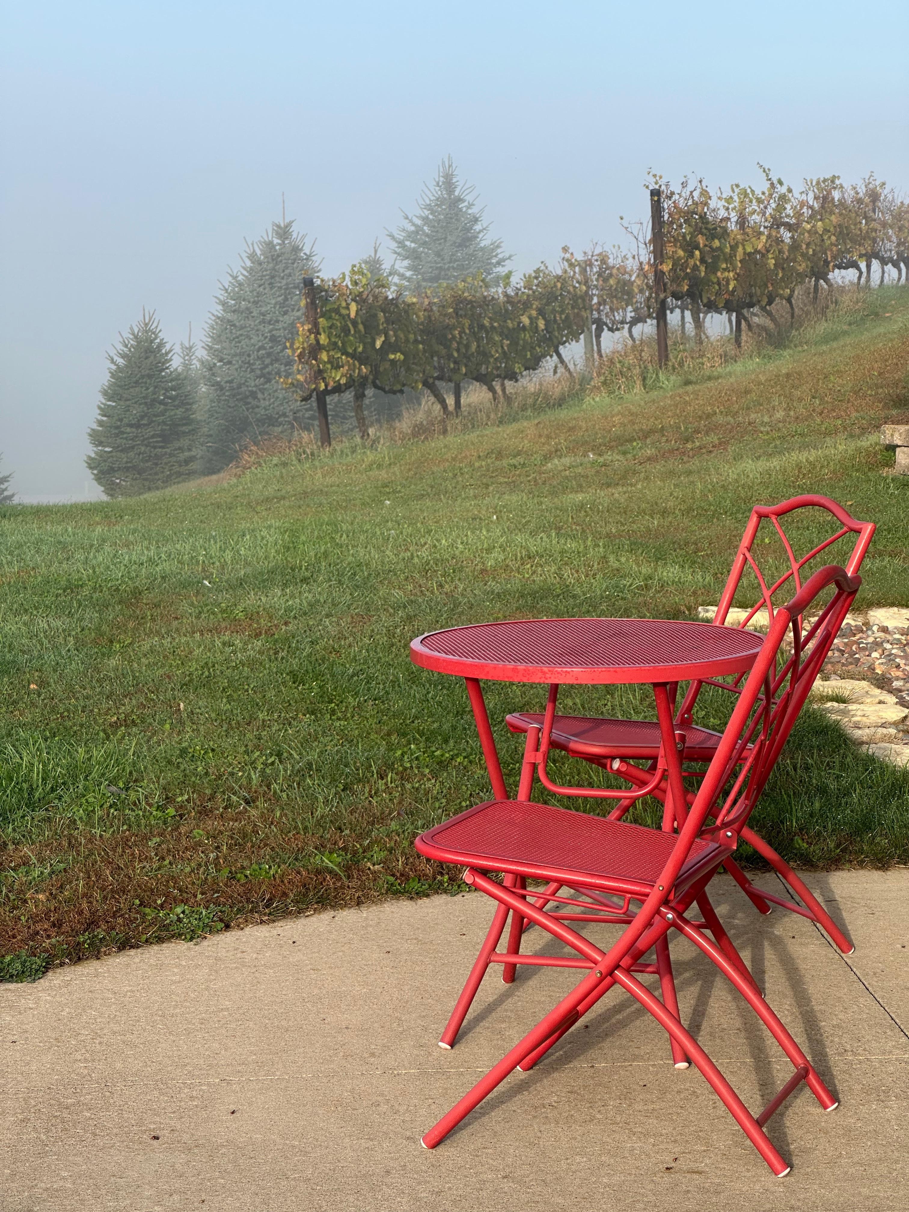 Seating area outside of the hilltop building, overlooking the vineyard and surrounding area