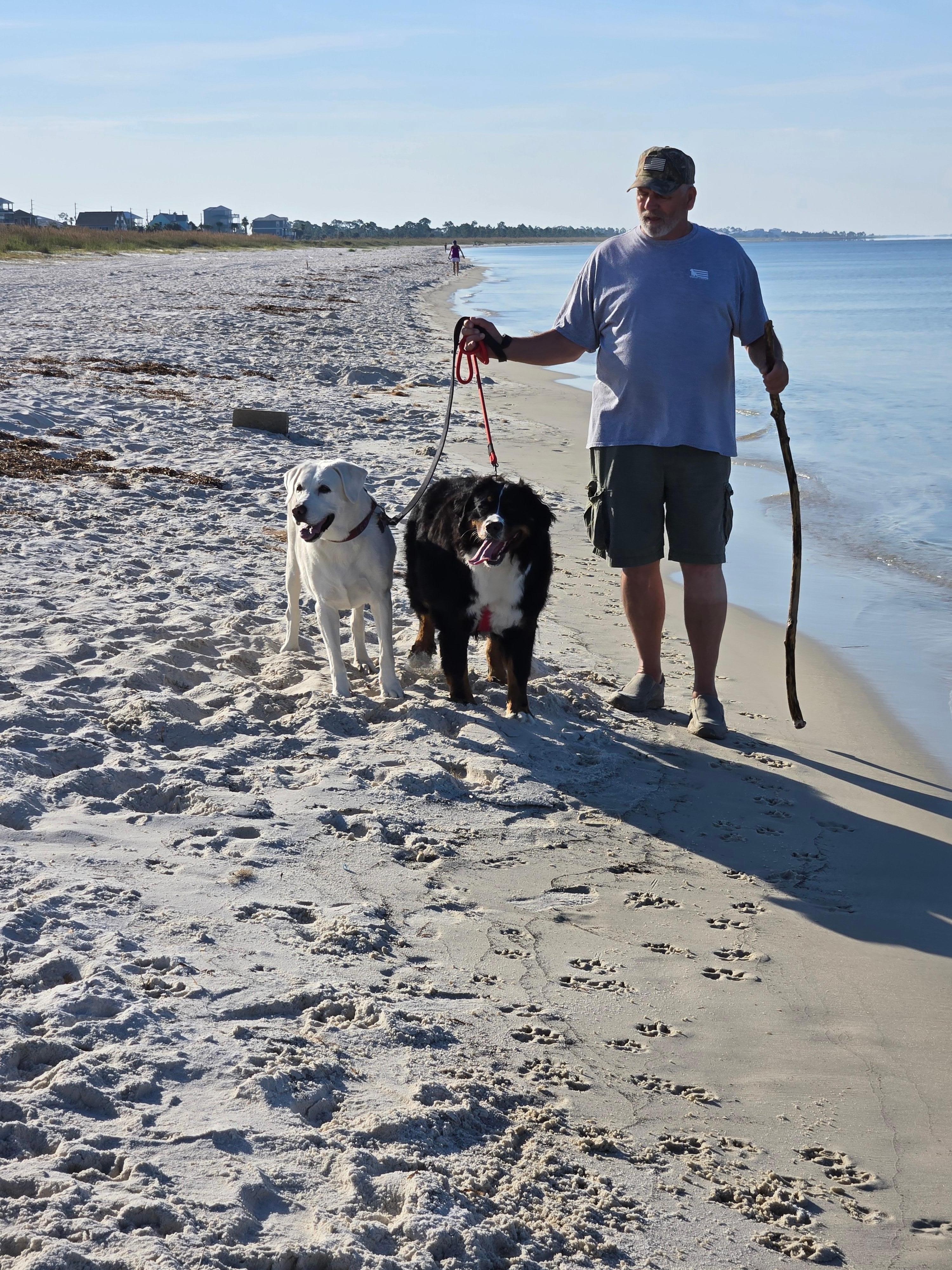 My husband on beach with our babies, Molly and Aspen.