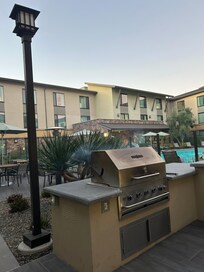 Grills and outdoor seating by the pool
