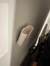 Fan remote holder hanging off the wall