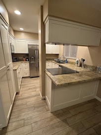Fully equipped kitchen, beautiful granite, new shaker cabinets, deep pantry, new modern stainless-steel appliances, huge basin sink, great peninsula bar— kitchen is larger than it seems!