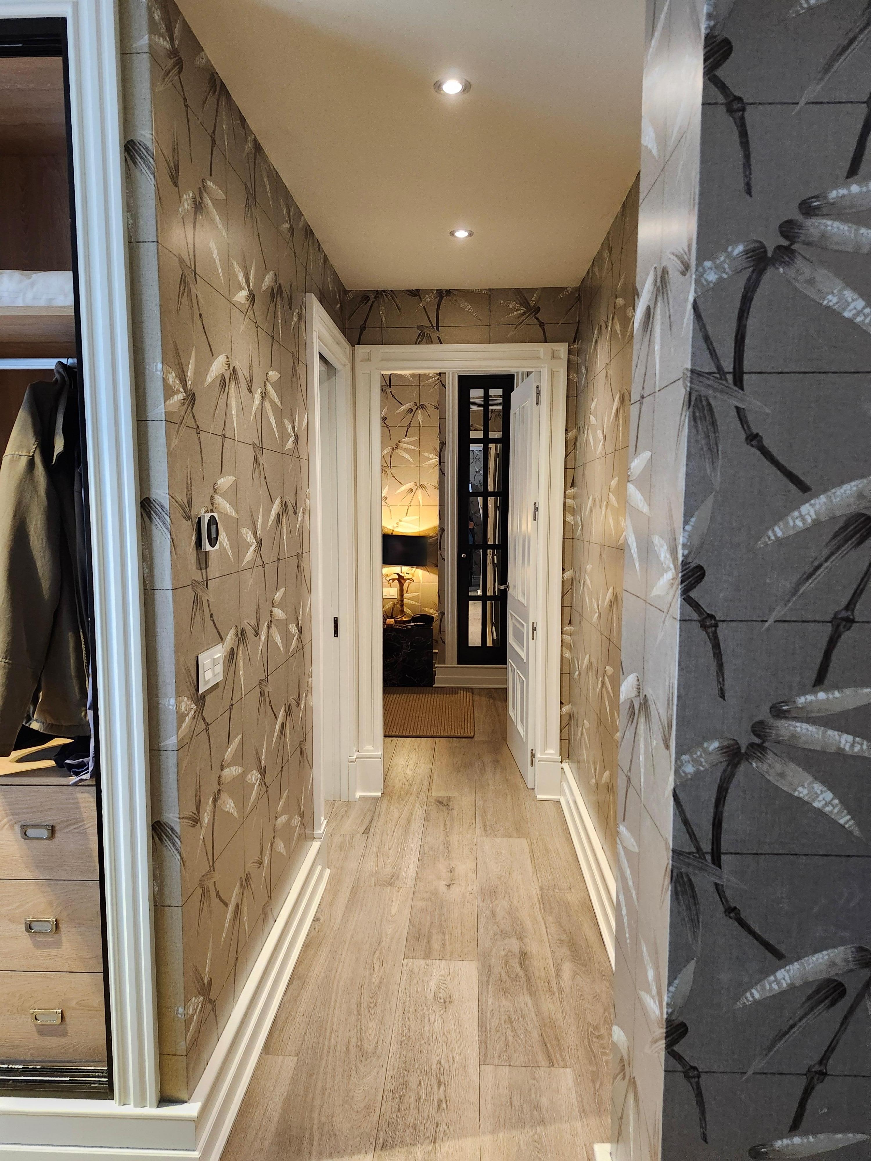 Hallway to bathroom with double sinks and walk in shower, bedroom with king bed