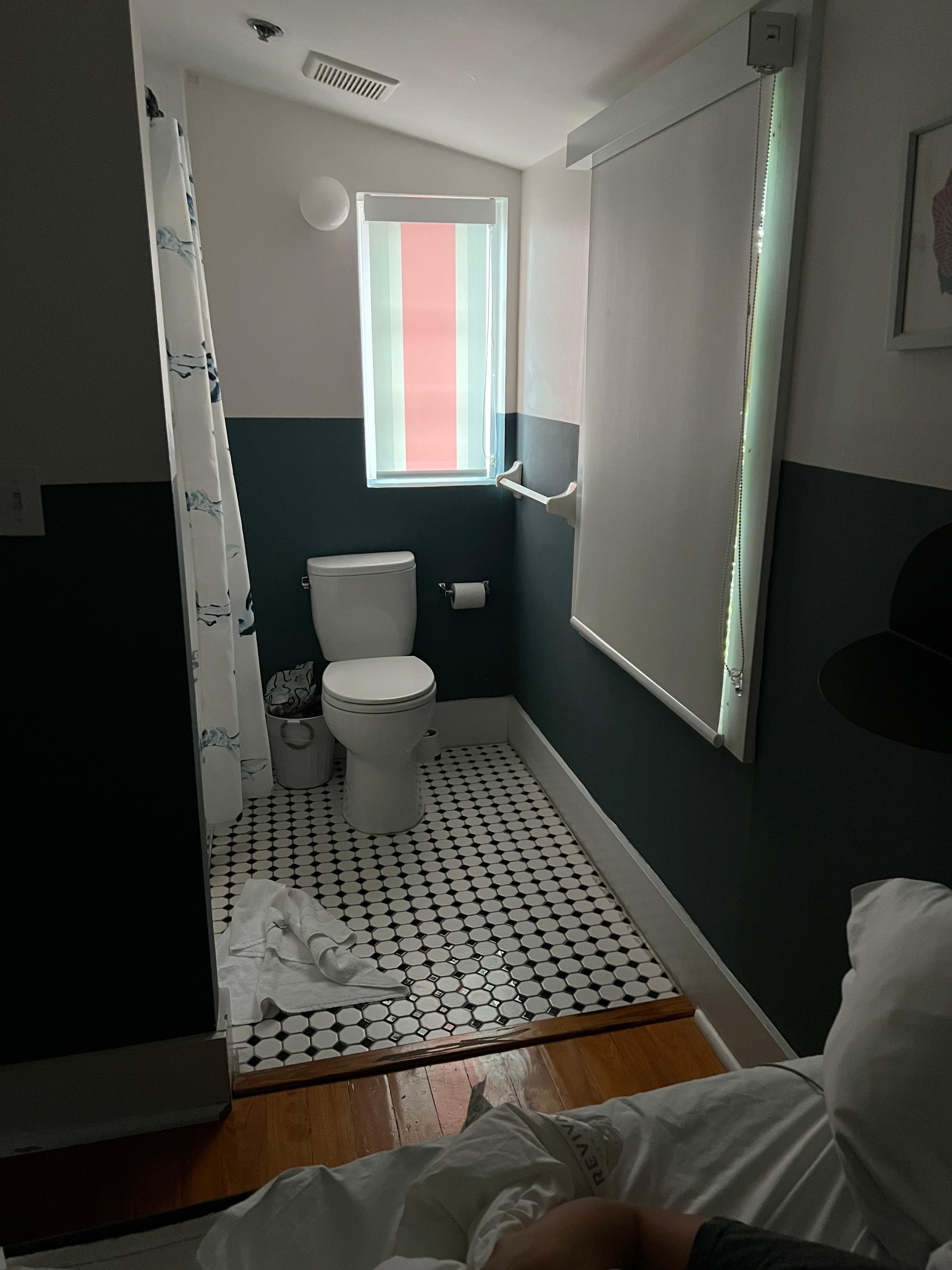 Toilet right in front of the bed and no door!