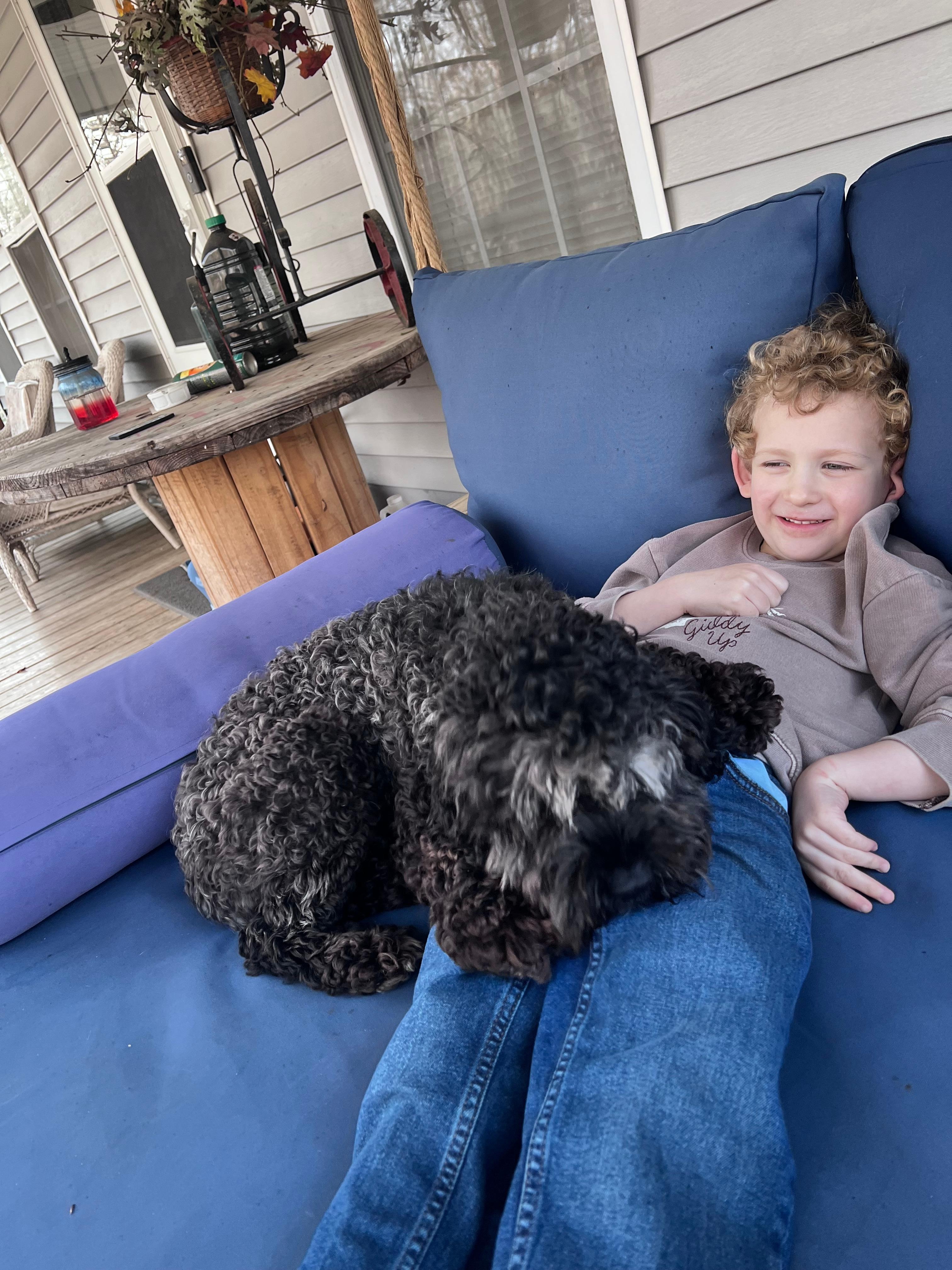 My son and dog enjoying the front porch swing 