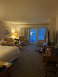 King room with balcony and fireplace.