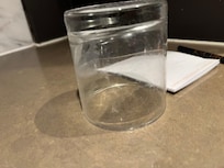 Dirty glass near bed