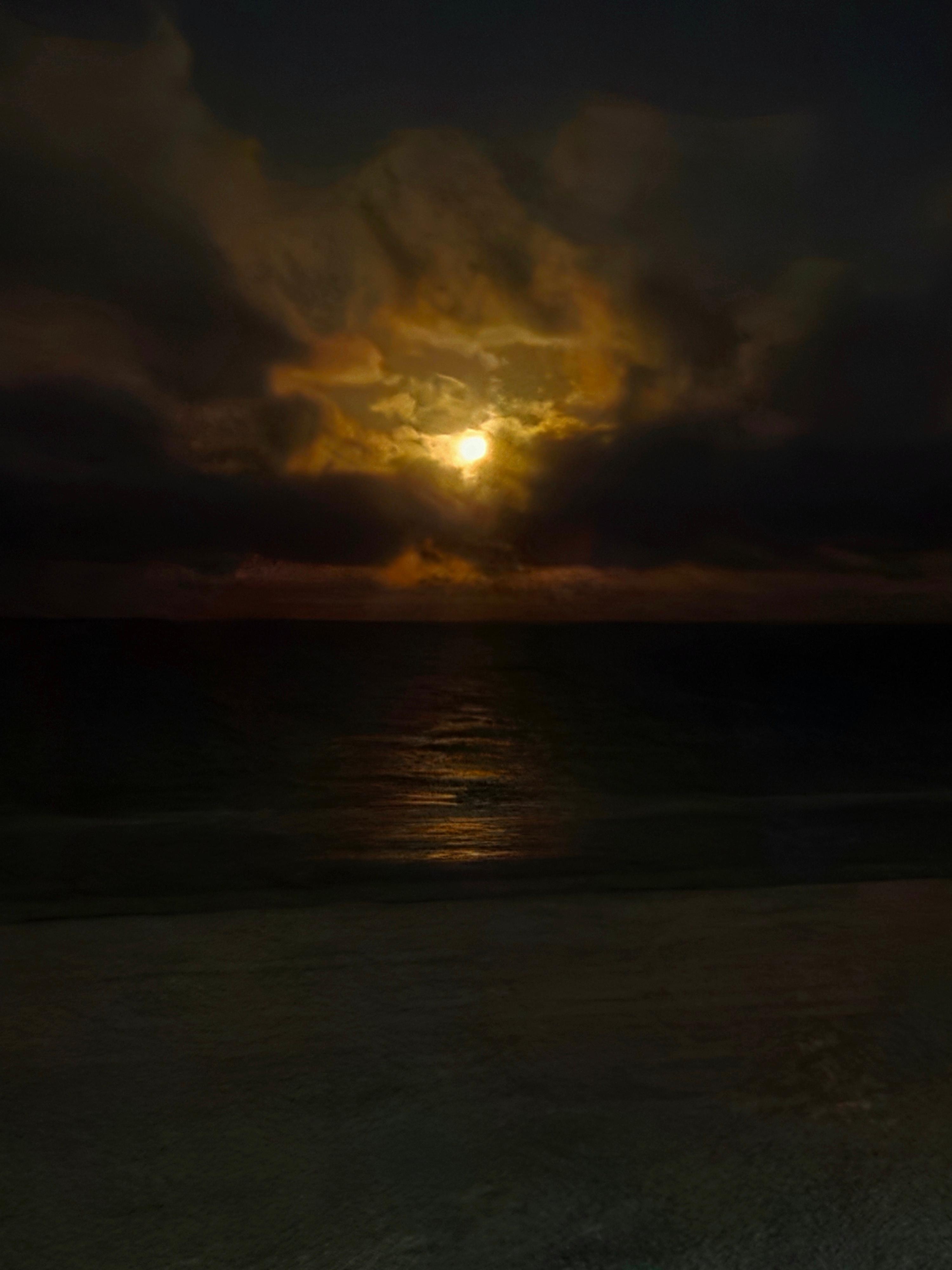 View of a nearly full moon taken through the living room window.